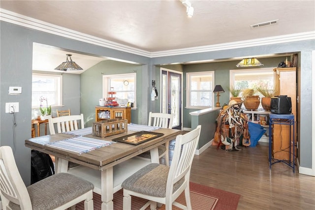 dining space featuring baseboards, crown molding, visible vents, and dark wood-style flooring