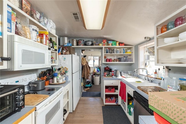 kitchen featuring a healthy amount of sunlight, white appliances, visible vents, and open shelves