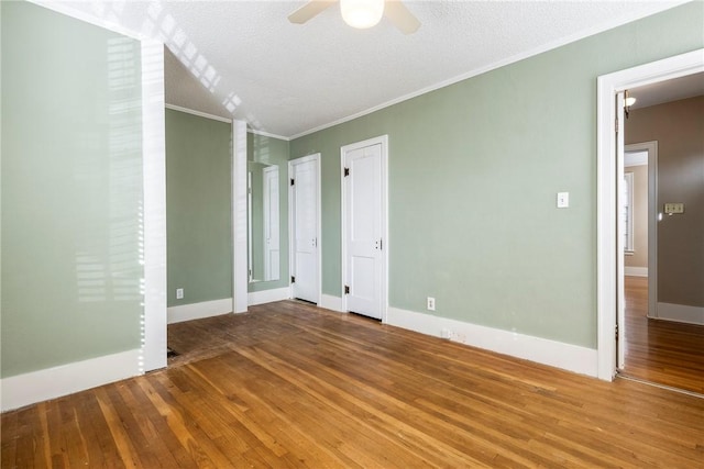 510 W Central Ave, Bentonville, AR 72712 - spare room featuring baseboards, ceiling fan, ornamental molding, wood finished floors, and a textured ceiling