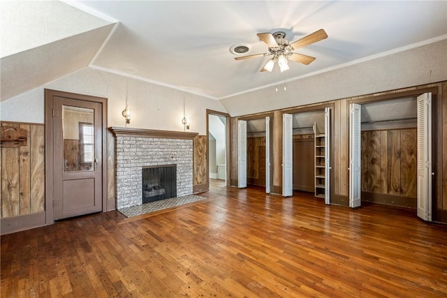510 W Central Ave, Bentonville, AR 72712 - unfurnished living room with lofted ceiling, dark wood-type flooring, a ceiling fan, a brick fireplace, and crown molding