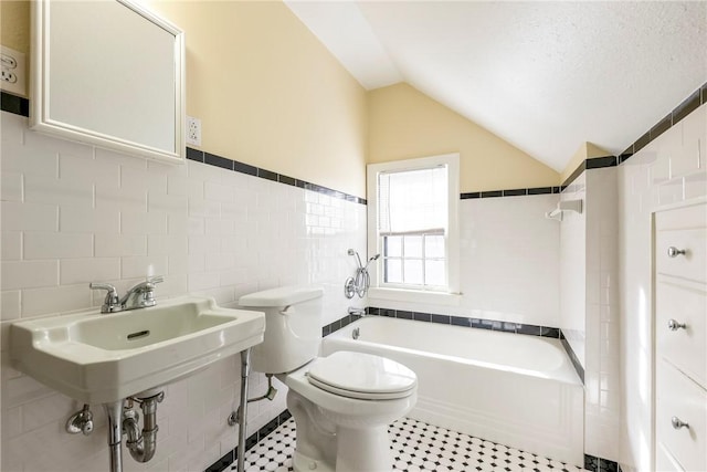 510 W Central Ave, Bentonville, AR 72712 - full bath featuring a tub to relax in, tile walls, toilet, vaulted ceiling, and a textured ceiling