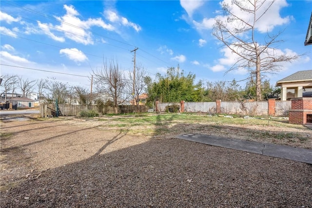 510 W Central Ave, Bentonville, AR 72712 - view of yard featuring a fireplace and fence