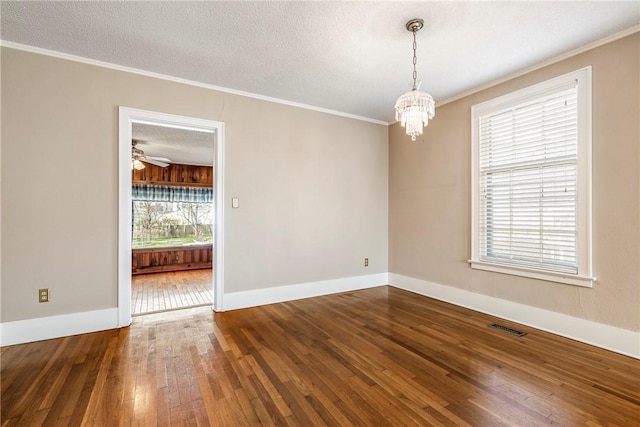 510 W Central Ave, Bentonville, AR 72712 - unfurnished room with a textured ceiling, a notable chandelier, wood finished floors, visible vents, and crown molding