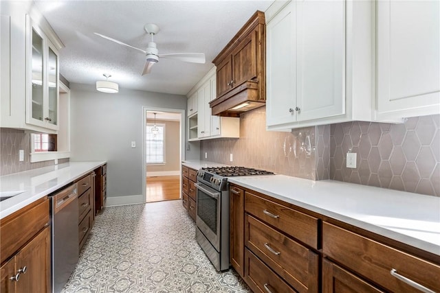 510 W Central Ave, Bentonville, AR 72712 - kitchen with light countertops, appliances with stainless steel finishes, glass insert cabinets, a ceiling fan, and white cabinets
