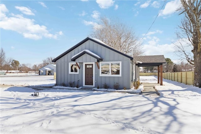 view of front facade with board and batten siding and fence