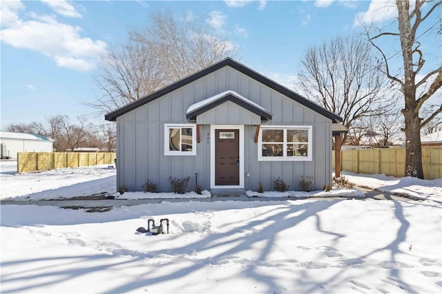 view of front facade featuring fence and board and batten siding