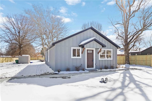 view of front of property with fence and board and batten siding