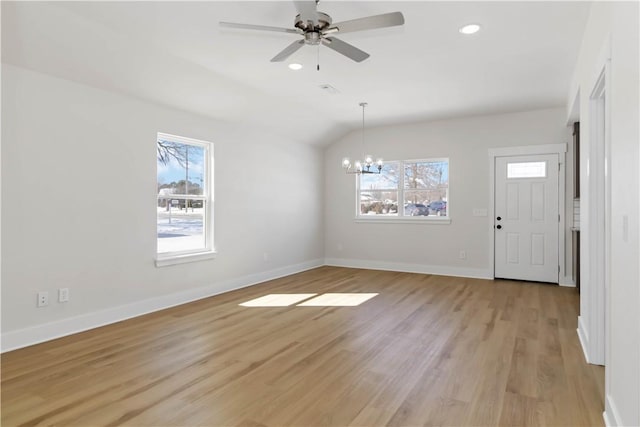 interior space featuring recessed lighting, baseboards, lofted ceiling, light wood-style floors, and ceiling fan with notable chandelier