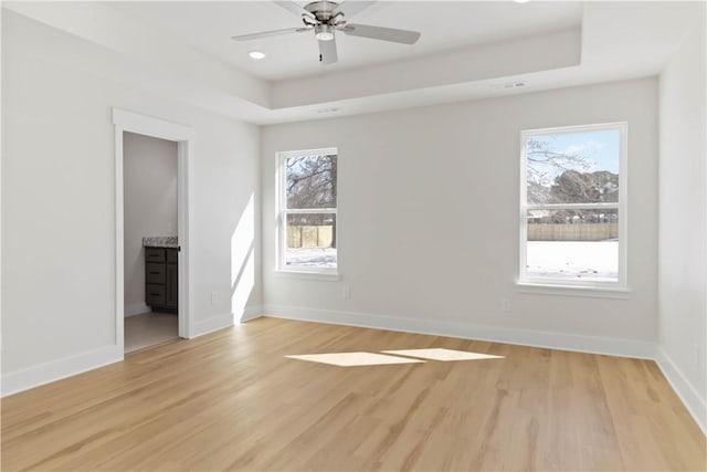 805 S W End St, Springdale, AR 72764 - spare room featuring light wood-type flooring, plenty of natural light, ceiling fan, a raised ceiling, and recessed lighting