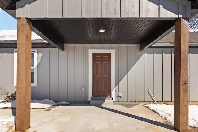 property entrance featuring board and batten siding