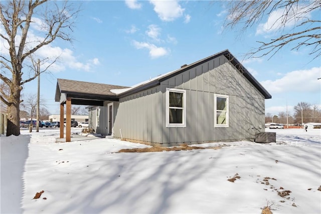 snow covered property featuring board and batten siding