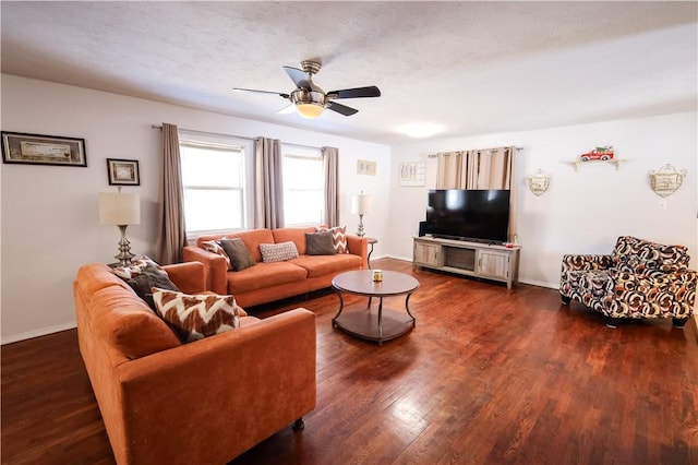 living area featuring a textured ceiling, ceiling fan, dark wood-type flooring, and baseboards