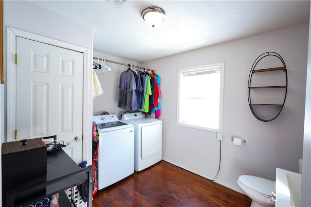 laundry room with laundry area, dark wood-type flooring, and washer and dryer