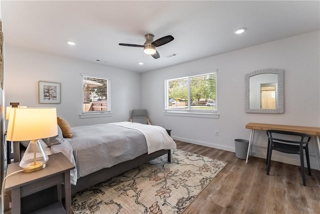 bedroom with recessed lighting, wood finished floors, a ceiling fan, visible vents, and baseboards