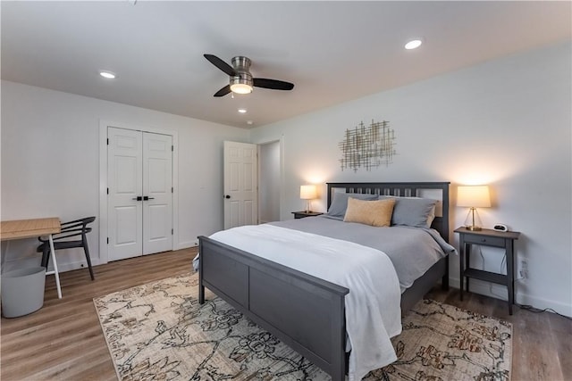 bedroom featuring ceiling fan, recessed lighting, wood finished floors, and baseboards