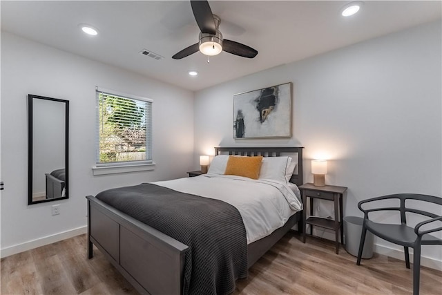 bedroom featuring visible vents, baseboards, wood finished floors, and recessed lighting