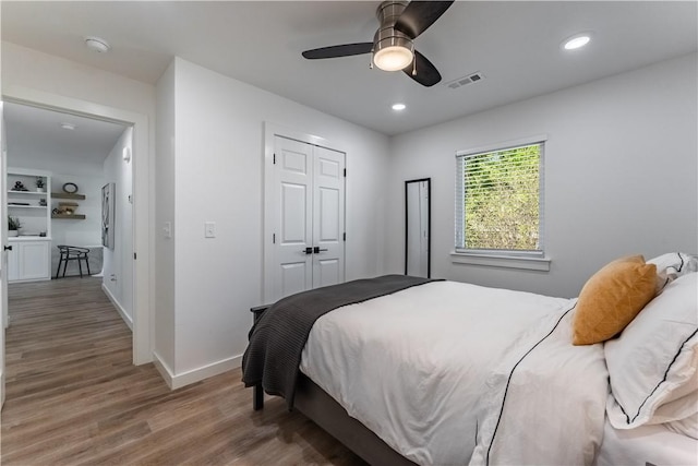 bedroom featuring baseboards, visible vents, wood finished floors, and recessed lighting