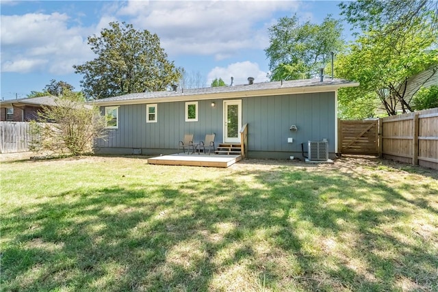 back of property featuring a yard, entry steps, a gate, cooling unit, and a fenced backyard