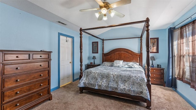 carpeted bedroom with visible vents, baseboards, vaulted ceiling, and a ceiling fan