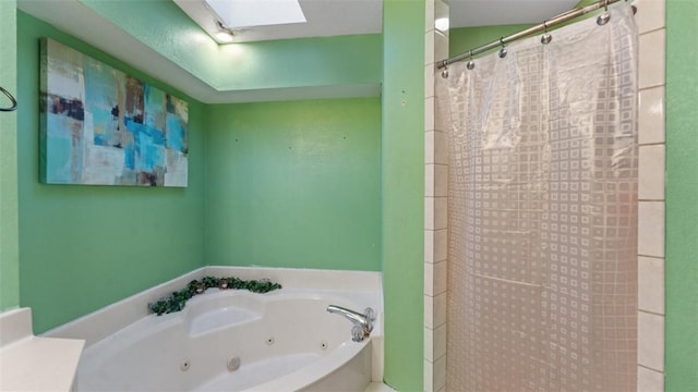 bathroom featuring a jetted tub, a skylight, and a shower with shower curtain