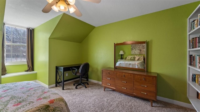 bedroom featuring light carpet, vaulted ceiling, baseboards, and ceiling fan