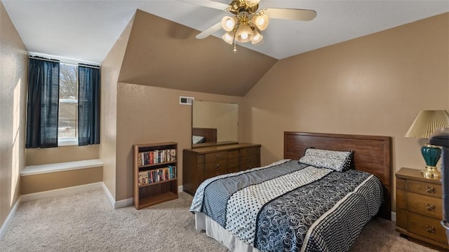 bedroom featuring baseboards, visible vents, light colored carpet, ceiling fan, and vaulted ceiling