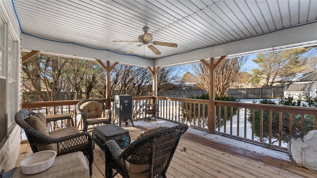 wooden terrace featuring a fenced backyard and a ceiling fan