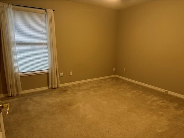 carpeted spare room with baseboards