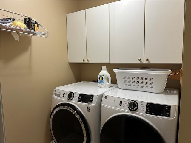 laundry room featuring washer and dryer and cabinet space