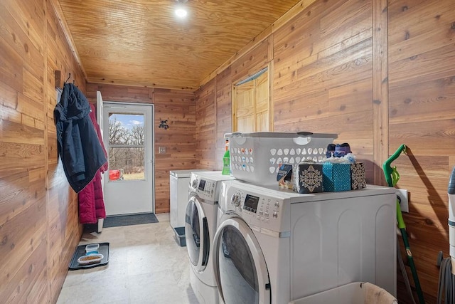 laundry room featuring washer and dryer, laundry area, wooden ceiling, and wood walls