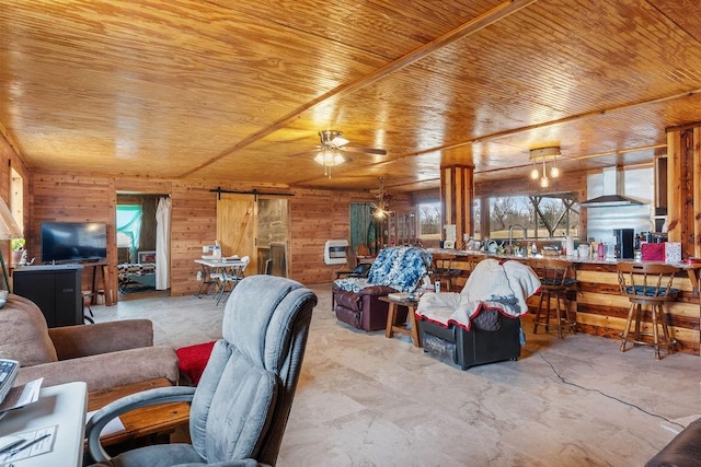 living room with ceiling fan, wood ceiling, wood walls, and a barn door