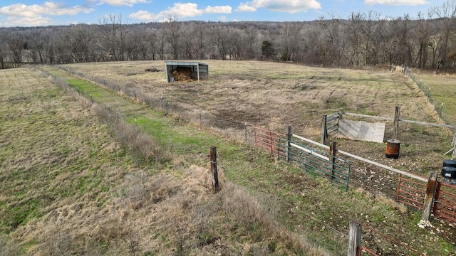 view of yard featuring fence and a rural view