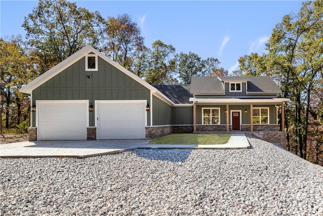 craftsman inspired home with an attached garage, driveway, and board and batten siding