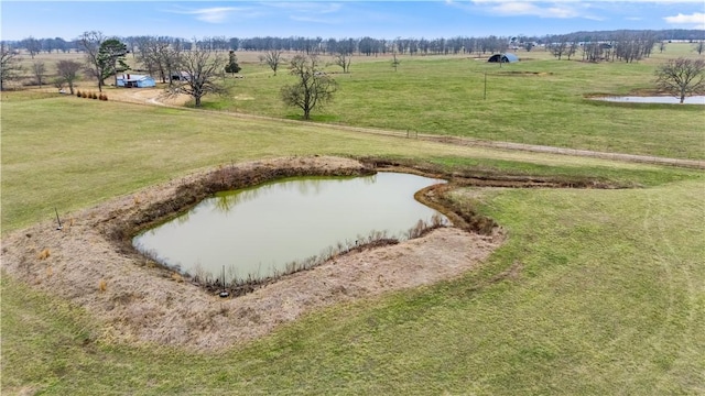 view of home's community featuring a water view, a lawn, and a rural view