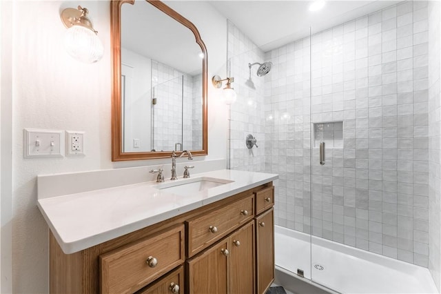 full bathroom with a shower stall and vanity