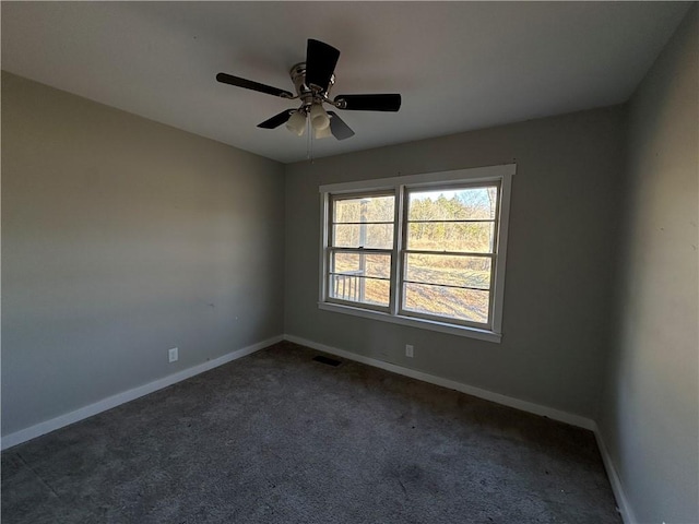 carpeted empty room with ceiling fan, visible vents, and baseboards