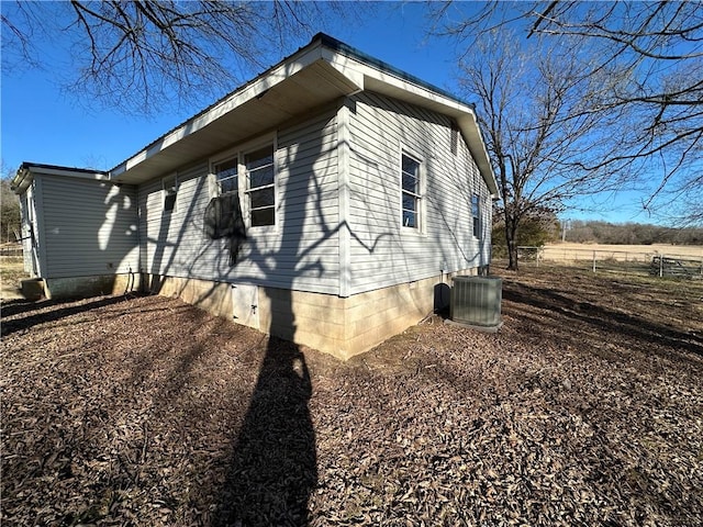 view of property exterior featuring crawl space and cooling unit