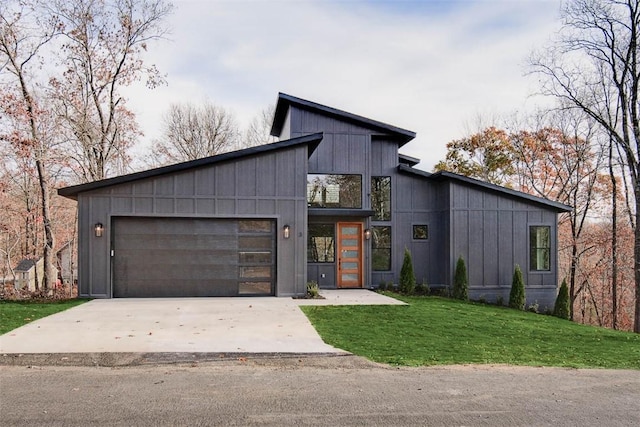 modern home with a garage, concrete driveway, board and batten siding, and a front yard