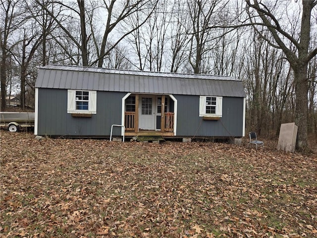 view of front of house with metal roof and an outdoor structure