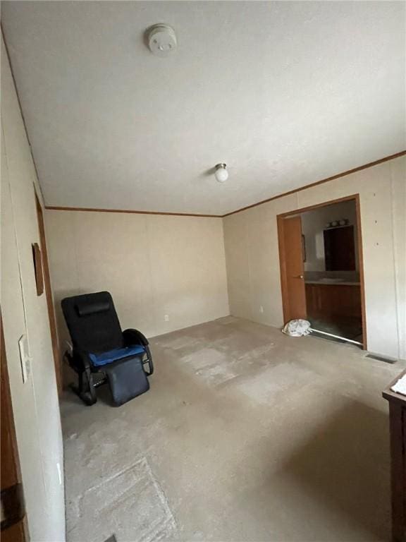 interior space featuring crown molding and unfinished concrete floors