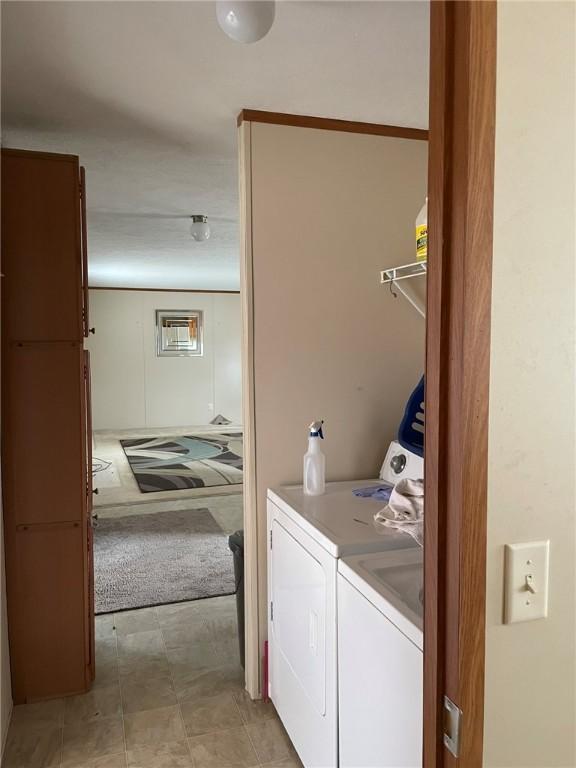 washroom featuring laundry area and washing machine and clothes dryer