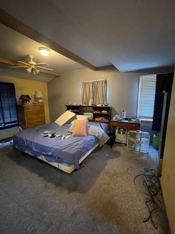 carpeted bedroom featuring ceiling fan and beam ceiling