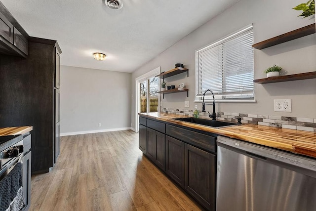 kitchen featuring a sink, appliances with stainless steel finishes, visible vents, and open shelves