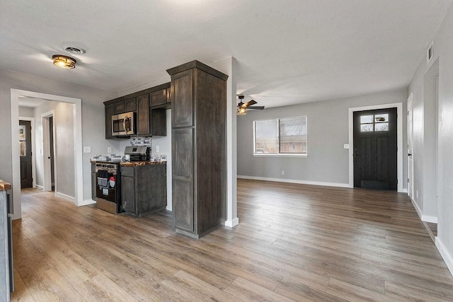 kitchen featuring dark brown cabinetry, visible vents, appliances with stainless steel finishes, and light wood-type flooring