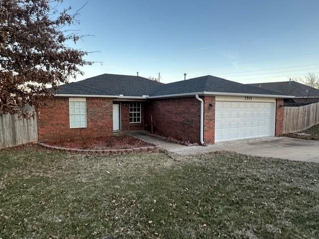 ranch-style house with brick siding, concrete driveway, a front yard, fence, and a garage