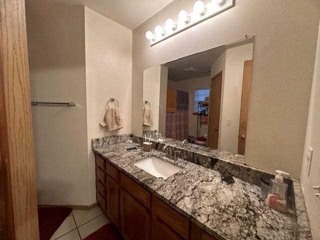 bathroom with tile patterned floors and vanity