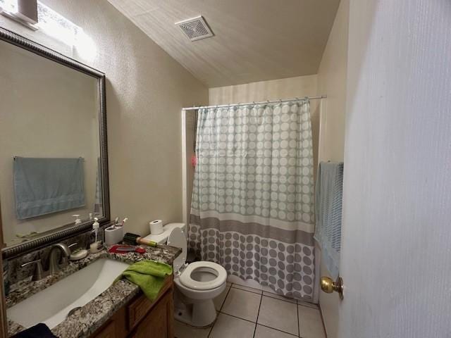 full bath featuring toilet, vanity, visible vents, and tile patterned floors