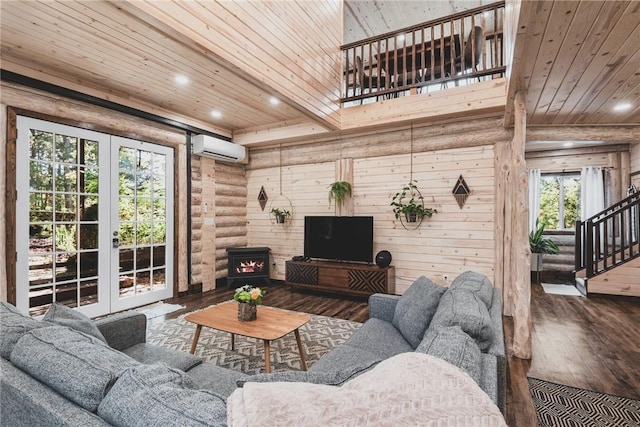 living area with wooden ceiling, recessed lighting, wood finished floors, a wall mounted AC, and a wood stove