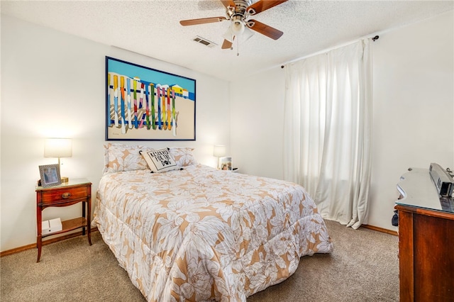 bedroom featuring baseboards, visible vents, a textured ceiling, and light colored carpet