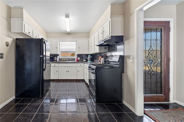 kitchen with dark countertops, under cabinet range hood, black appliances, white cabinetry, and a sink